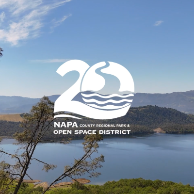 Photo of Lake Hennessey from Conn Peak with the 20th Anniversary NOSD logo.